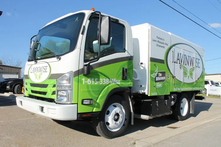 The LawnWise box truck with the company’s green logo